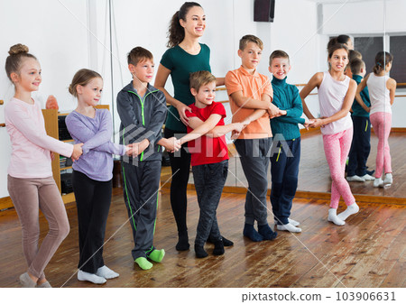 Boys and girls studying folk dance in studio Boys and girls studying folk dance in studio 103906631