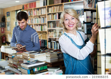 Woman searching for new book Woman searching for new book 103906835