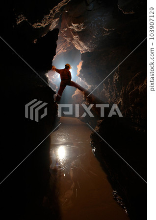 Man exploring a cave 103907129