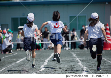 Students sprinting at an elementary school athletic meet 103907394