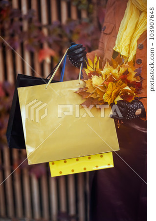 Closeup on woman in orange trench coat 103907648