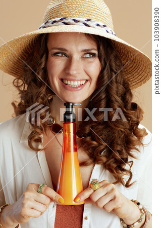 happy elegant woman in blouse and shorts on beige 103908390