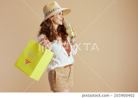 happy woman in blouse and shorts against beige happy woman in blouse and shorts against beige 103908402