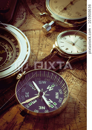 Old vintage compass and travel instruments on ancient map Old vintage compass and travel instruments on ancient map 103908636
