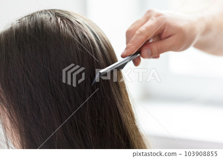 Hairdresser does hair style of woman Hairdresser does hair style of woman 103908855