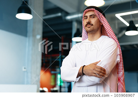 Successful muslim businessmen in traditional outfit in his office Successful muslim businessmen in traditional outfit in his office 103908907