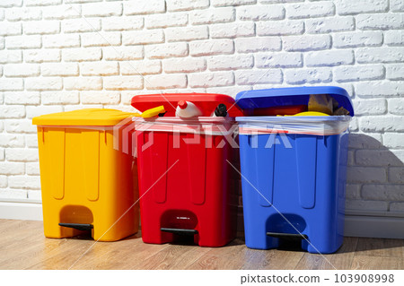 Trash cans full of waste in the building 103908998