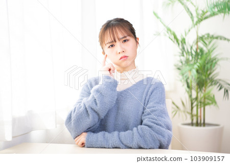 Young woman thinking in her room Young woman thinking in her room 103909157