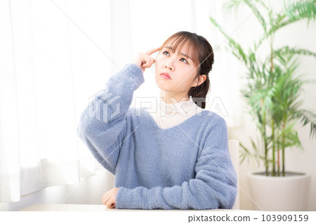 年輕女子在她的房間裡思考 年輕女子在她的房間裡思考 103909159