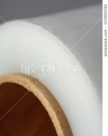 Roll of transparent polyethylene cling film on gray background Roll of transparent polyethylene cling film on gray background 103909398