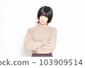 A young woman thinking in front of a white background 103909514