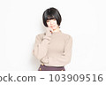 A young woman thinking in front of a white background 103909516