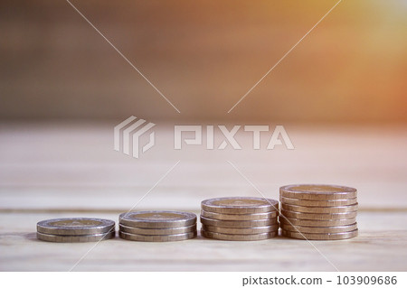 Coin stacks on wood table background. Coin stacks on wood table background. 103909686