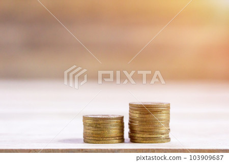 Coin stacks on wood table background. Coin stacks on wood table background. 103909687