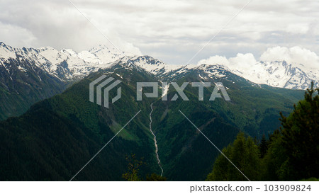 A panoramic view on the snow-capped peaks. Greater Caucasus Mountain Range 103909824