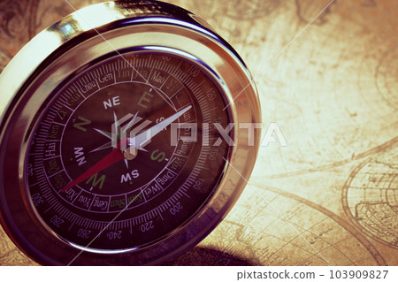 Old compass on vintage map Old compass on vintage map 103909827