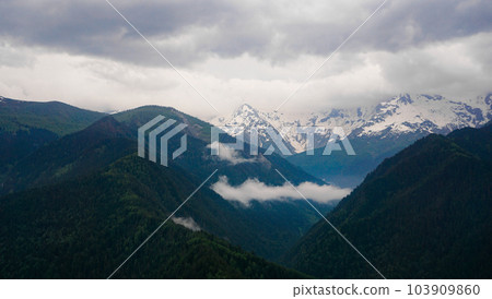A panoramic view on the snow-capped peaks. Greater Caucasus Mountain Range 103909860