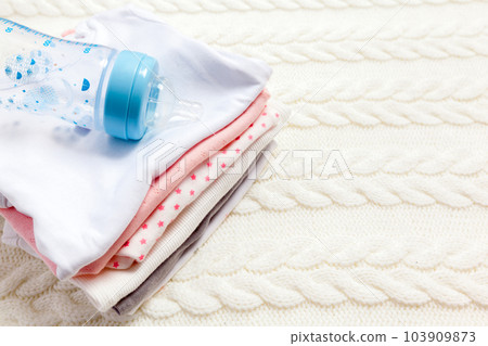 close up of baby clothes for newborn on table close up of baby clothes for newborn on table 103909873
