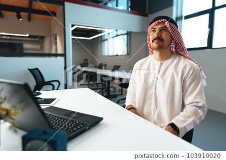 Successful muslim businessmen in traditional outfit in his office Successful muslim businessmen in traditional outfit in his office 103910020