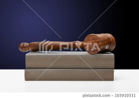 Wooden gavel and books on wooden table Wooden gavel and books on wooden table 103910331