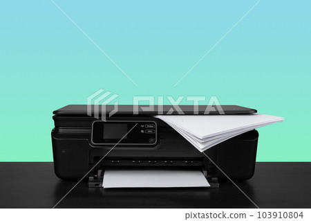 Home laser printer on desk against green background Home laser printer on desk against green background 103910804