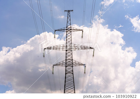 High voltage towers with sky background. Power line support with wires for electricity transmission. High voltage grid tower with wire cable at distribution station. Energy industry, energy saving High voltage towers with sky background. Power line support with wires for electricity transmission. High voltage grid tower with wire cable at distribution station. Energy industry, energy saving 103910922