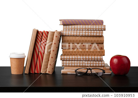 Stack of books and apple on tabletop against white background Stack of books and apple on tabletop against white background 103910953