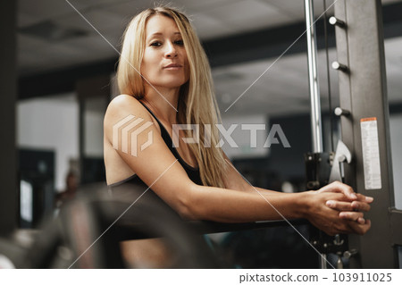 Fitness woman in sport outfit exercising in gym Fitness woman in sport outfit exercising in gym 103911025