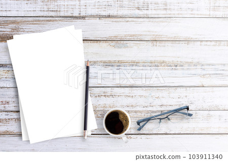 Office desk glasses,pencil,coffee cup and white paper on a white wood table background. 103911340