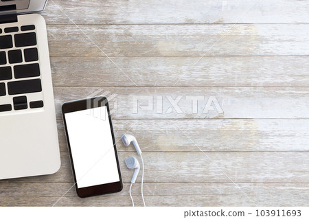 Close up smart phone,laptop computer and white earphone on brown old wood background 103911693