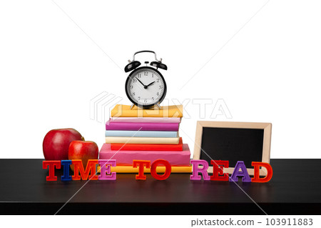Stack of books and alarm clock, time to read concept Stack of books and alarm clock, time to read concept 103911883