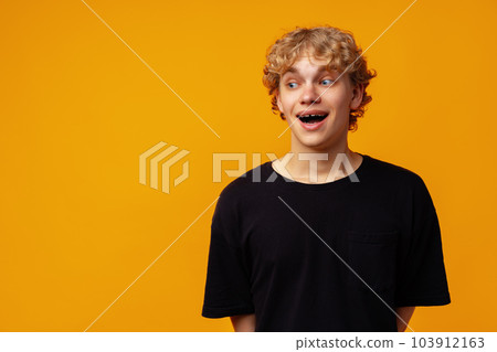 Young man over yellow background with surprise facial expression 103912163