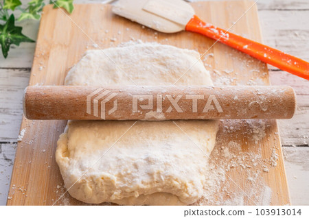 Spread the butter on the bread dough 103913014