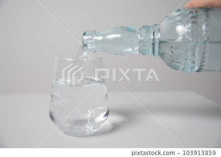 Close Up The Pouring Purified Fresh Drink Water From The Bottle On