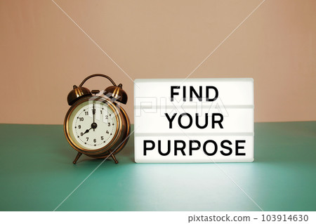 Find Your Purpose text message on paper card with wooden easel and alarm clock Find Your Purpose text message on paper card with wooden easel and alarm clock 103914630