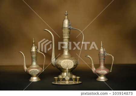 Set of traditional Brass Surai (pot) on Brown background Set of traditional Brass Surai (pot) on Brown background 103914873