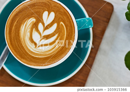 Selective focus cup of hot latte art coffee on wooden table Selective focus cup of hot latte art coffee on wooden table 103915366