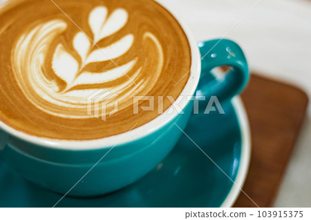 Selective focus cup of hot latte art coffee on wooden table 103915375