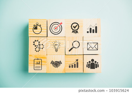 Business target concept with a wooden cube block step. Action Plan and Goal icons symbolize success. Project management and company strategy on a blue background. Business target concept with a wooden cube block step. Action Plan and Goal icons symbolize success. Project management and company strategy on a blue background. 103915624