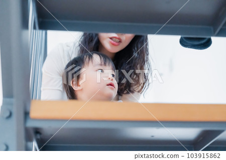 A 1-year-old boy climbing the stairs of the house 103915862
