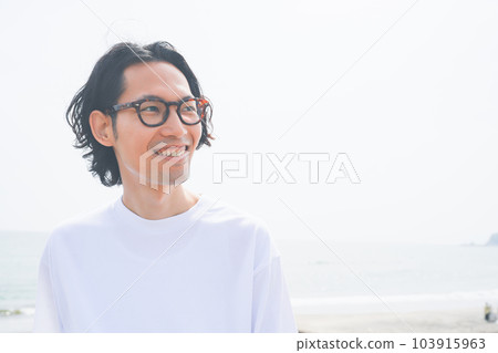 A man in a T-shirt sunbathing on the beach A man in a T-shirt sunbathing on the beach 103915963