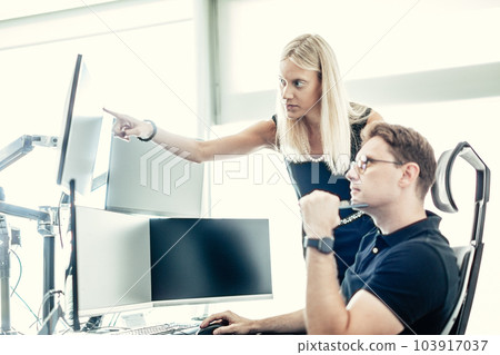 Stock broker business team trading online watching charts and data analyses on multiple computer screens in modern corporate work station office Stock broker business team trading online watching charts and data analyses on multiple computer screens in modern corporate work station office 103917037