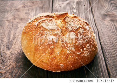 Loaf of fresh made white bread on wooden table background Loaf of fresh made white bread on wooden table background 103917217