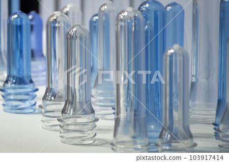 Close up scene of group of preform shape of PET bottle products. Close up scene of group of preform shape of PET bottle products. 103917414