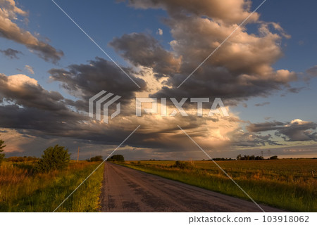 Stormy sky at sunset in the pampas field, La Pampa, Argentina. 103918062