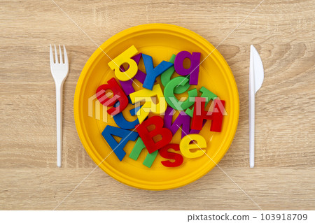 Fork, knife and plate with colored letters 103918709