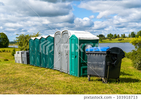 Portable  toilets and plastic hand washing sink stations on the public park 103918713