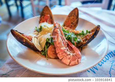 Classic seafood risotto, greek cuisine, Zakynthos taverna background. 103918841
