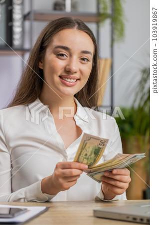 Rich happy business woman working on laptop pc counting money cash, calculate earnings income profit Rich happy business woman working on laptop pc counting money cash, calculate earnings income profit 103919867