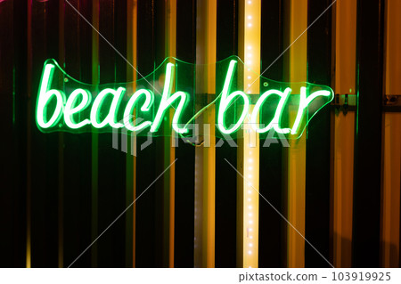 Neon signboard beach bar close-up. 103919925